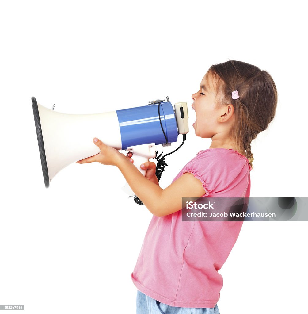 Little and loud Little girl shouting through megaphone over white background Girls Stock Photo