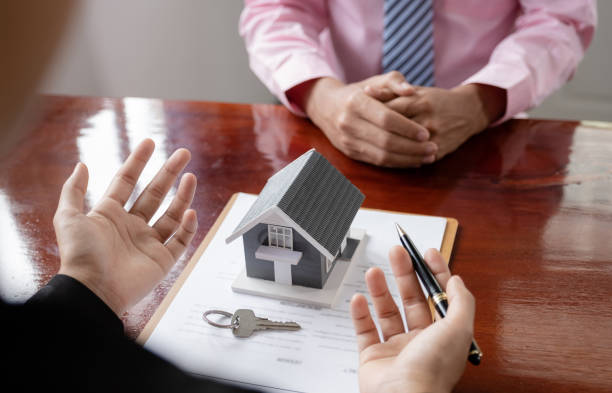 istock hand. The real estate agent explains the business contract 1532496137