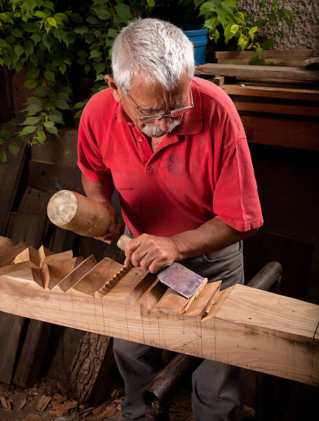 istock Old woodcarver working with mallet 153250636