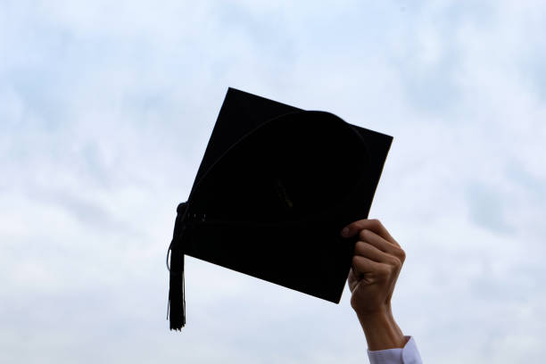 istock Student with congratulations, graduates wearing a graduation gown of university. 1532506721
