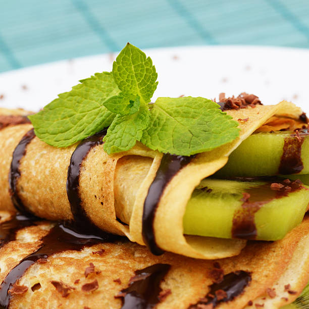 istock Kiwi crepes with chocolate syrup 153250746