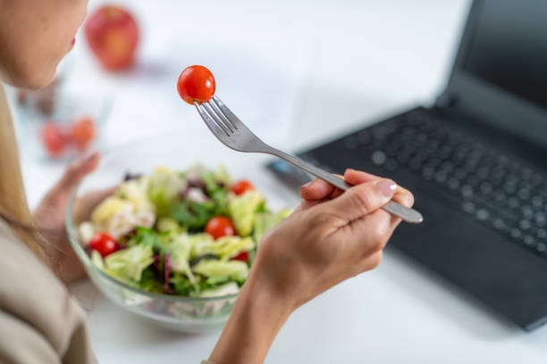 istock Woman Eating Fresh Salad at Workplace 1532528230