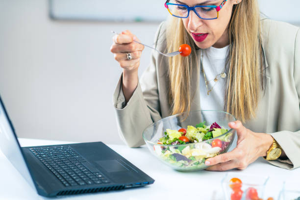 istock Woman Eating Fresh Salad at Workplace 1532530319