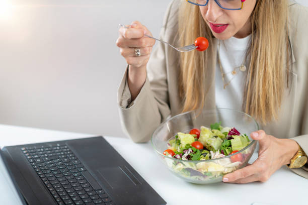 istock Woman Eating Fresh Salad at Workplace 1532530324