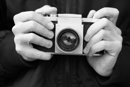 Old film camera in the hands (Black and White)