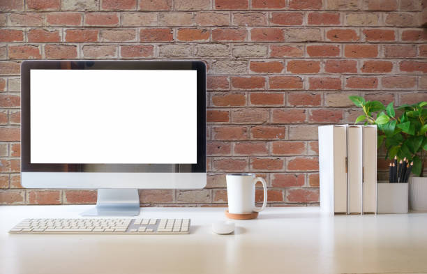 istock Front view of comfortable working space with computer, books and stationery on table. 1532537014