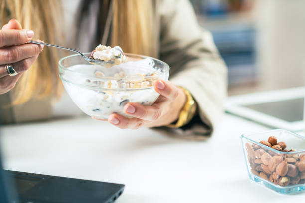 istock Nourishing Break: Woman Enjoys Muesli and Yogurt at Work 1532539610