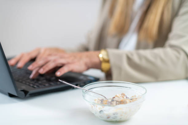 istock Woman Enjoys Muesli & Yogurt While Working 1532541131
