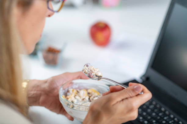 istock Woman Enjoys Muesli & Yogurt on Workplace 1532542164
