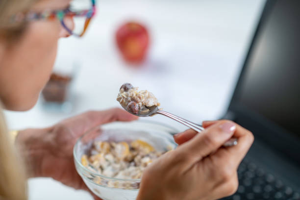 istock Woman Enjoys Muesli & Yogurt on Workplace 1532542680