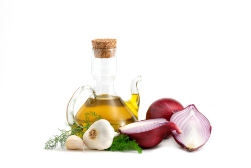 Red onions, olive oil and garlic isolated over white