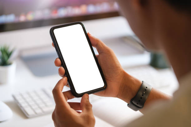 istock Mock up smartphone of hand holding black mobile phone with blank white screen. 1532549708