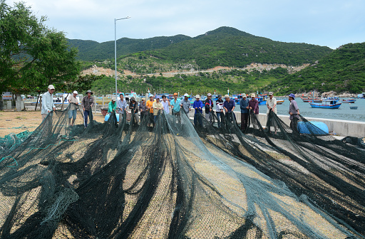 Ninh Thuan, Vietnam - Jan 27, 2016. Men working with fishing nets in the village in Vinh Hy Bay, Phan Rang, Vietnam. Phan Rang is one of famous destinations in southern Vietnam.