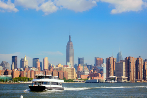 Cruise boat and skyline of New York City, USA.