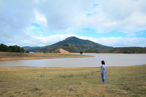 Dalat, Vietnam - Jan 24, 2016. People walking on the hill with pine tree forest in summer time.