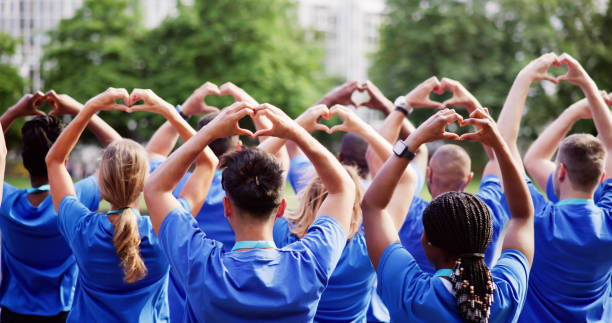 Diverse Young Charity Group Making Hearts stock photo