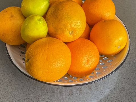 High angle view of bowl full of oranges and lemons
