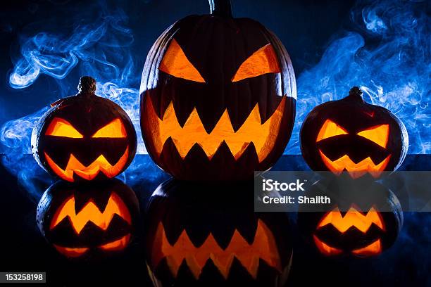 Three Halloween Pumpkins In The Smoke Background Stock Photo - Download Image Now - American Culture, Autumn, Bizarre