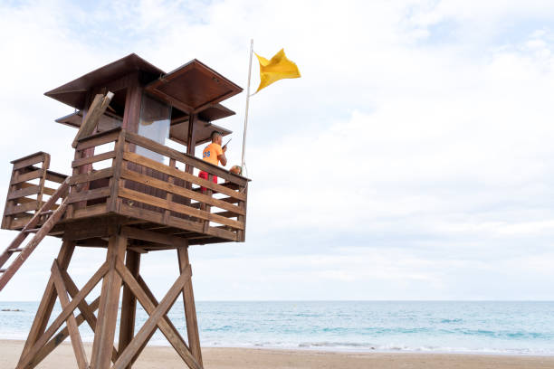 Rescuer using the radio standing in a control tower stock photo