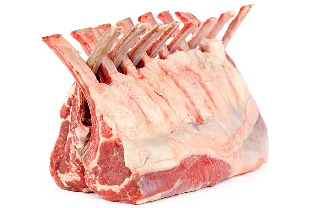 Raw rack of lamb against a white background Fresh Two Racks of Lamb with the ribs folded together Isolated on a white background rack of lamb stock pictures, royalty-free photos & images