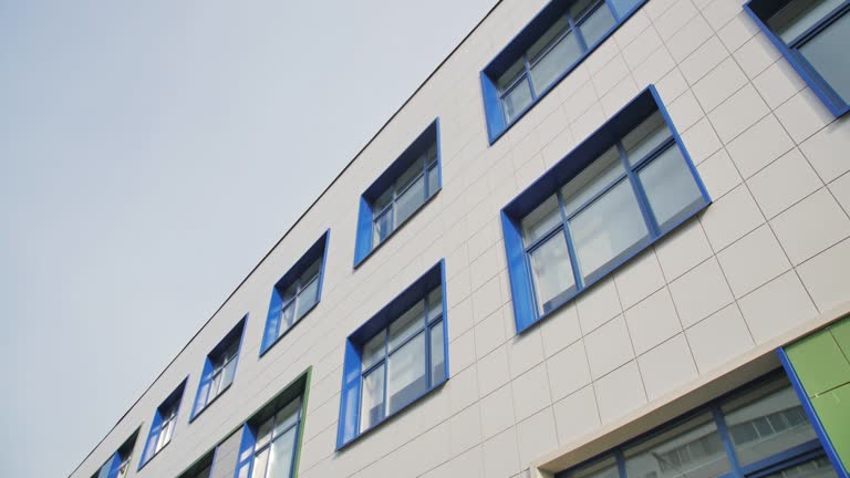 School building facade with color windows in city block