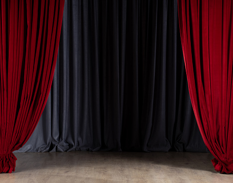 Empty stage with red velvet curtains. Theater stage with gray in-stage curtain and parquet floor