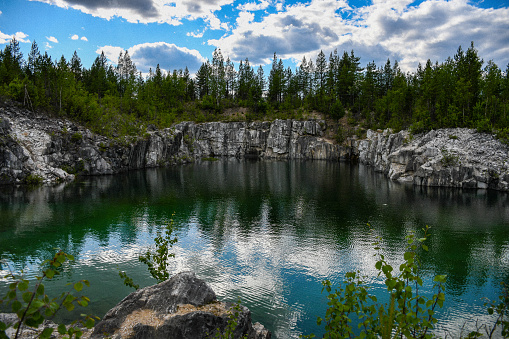 An old quarry with smaragd green water, just outside Jokkmokk, Norrbotten county, Sweden.