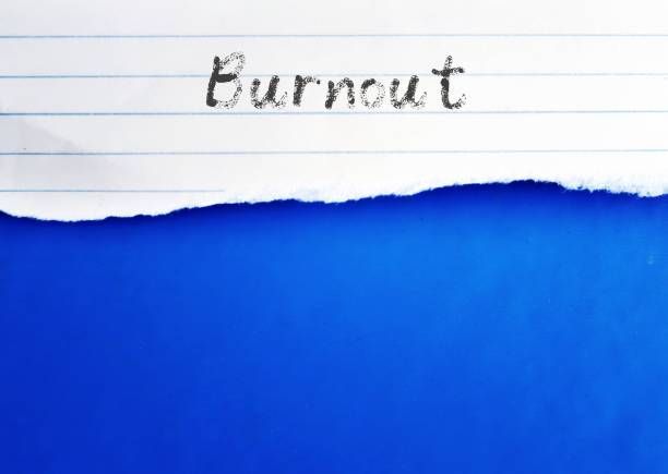 istock On blue copy space background, torn paper with grunge handwriting BURNOUT, means reaction to prolonged or chronic job stress lead to physical and emotional exhaustion state 1532612655