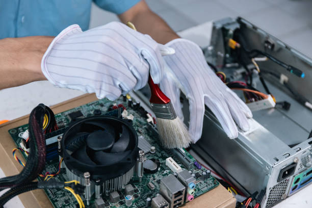 istock A technician is repairing a computer by cleaning the cooling fan. 1532615826