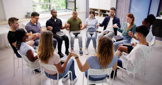 istock Group Of People Sitting Together Praying 1532620666