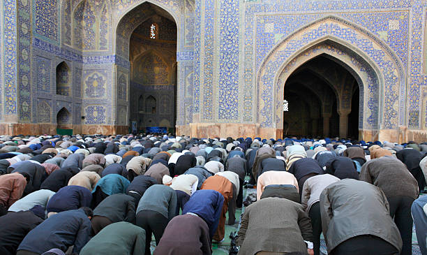 Muslim Friday mass prayer in Iran Muslim Friday mass prayer in Imam Mosque in Isfahan, Iran place of worship stock pictures, royalty-free photos & images