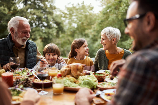 istock Happy multi-generation family having lunch in nature. 1532640446
