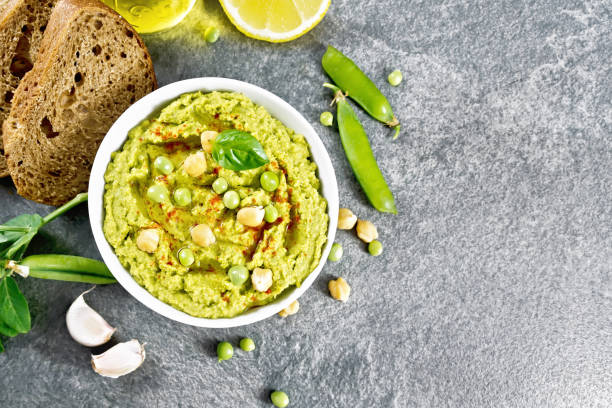 istock Hummus from green peas in bowl on granite table top 1532646810