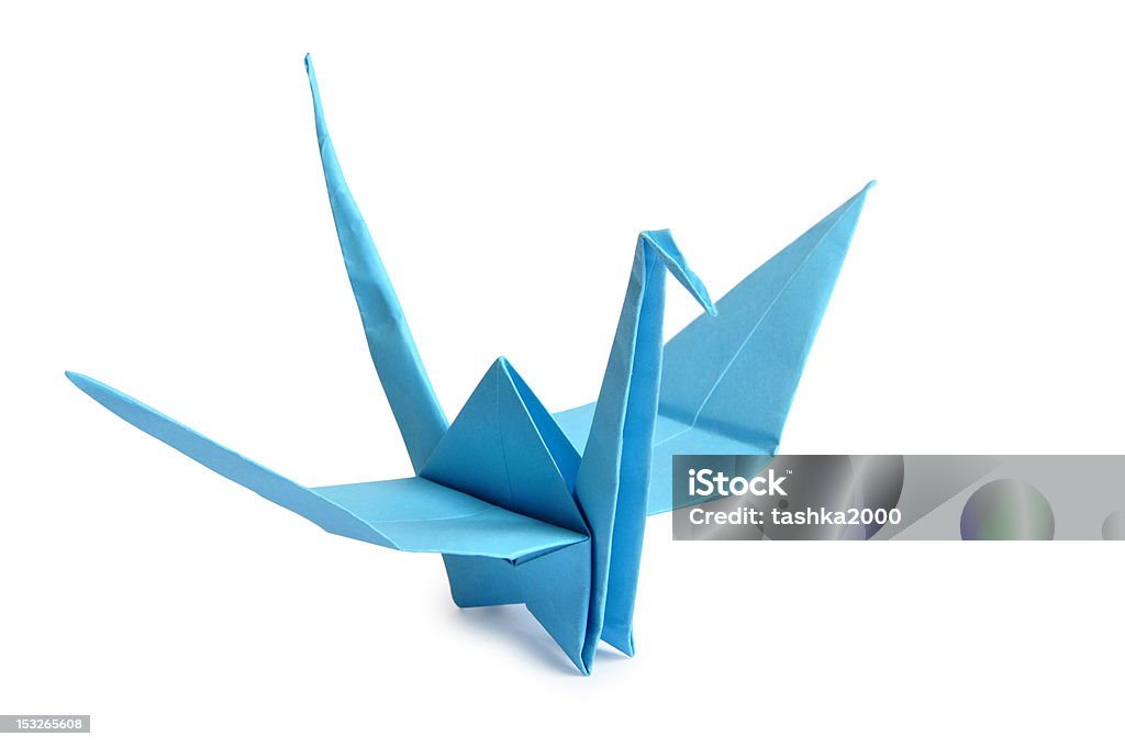 origami crane Traditional Japanese origami crane made from blue paper over white background Paper Crane Stock Photo