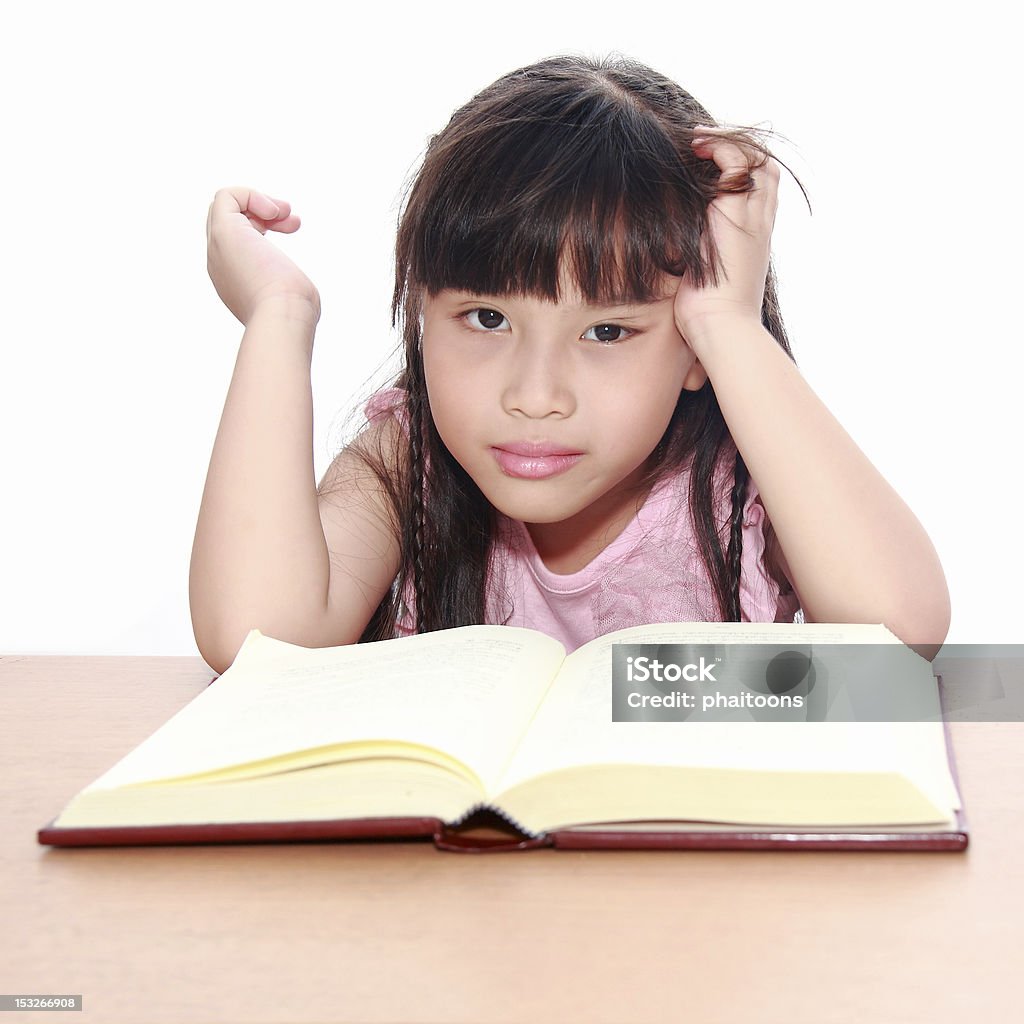 serious little girl  reading a book Book Stock Photo
