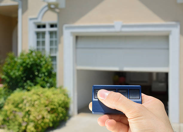 Garage Door Opener Garage Door Opener opening a residential garage door. remote controlled stock pictures, royalty-free photos & images