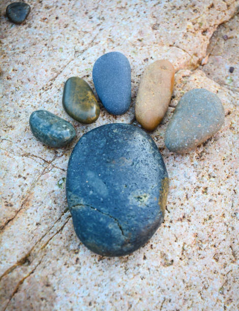 A foot by pebble on rock background, amazing concept from stone with yellow color on beach, awesome art product.