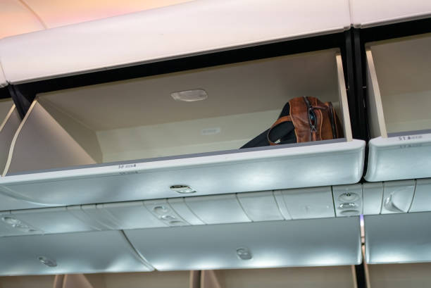 istock Overhead compartment for put luggage on airplane. 1532704716