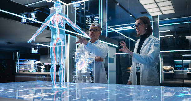 istock Two Bioengineers Working With Computer-Powered VFX Hologram Of Human Body And Organs In Futuristic Lab. Man And Woman Researching Blood Flow, Developing Innovative Healthcare Solutions. 1532708371