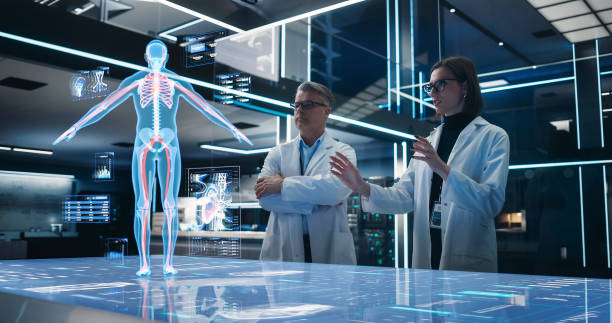 istock Two Bioengineers Working With Computer-Powered VFX Hologram Of Human Body And Organs In Futuristic Lab. Man And Woman Researching Blood Flow, Developing Innovative Technological Healthcare Solutions. 1532708885