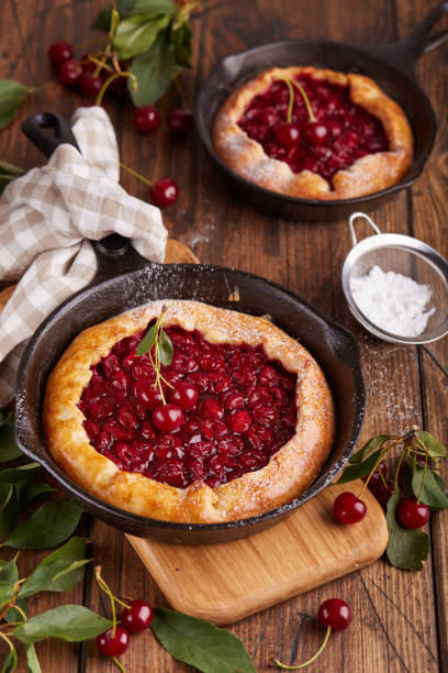 Open sweet pie tart with cherries and sugar powder