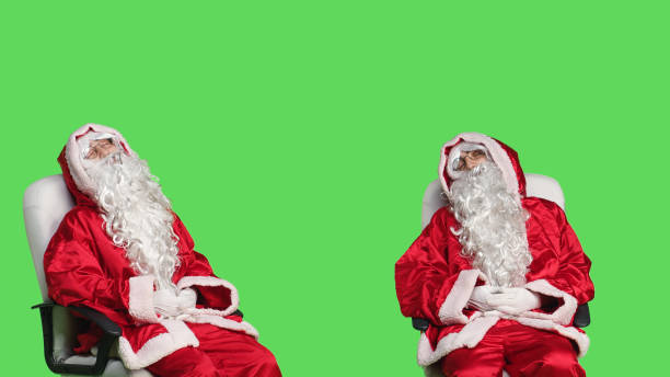 istock Father christmas falling asleep on chair 1532731365