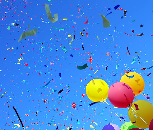 istock Skyward view of colorful balloons and falling confetti 153273668