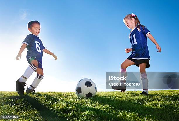 Young Soccer Players Kicking Ball Stock Photo - Download Image Now - Soccer, Child, Girls