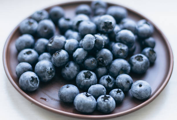 istock Blueberries on the plate. Blueberries in ceramic bowl on white background. Antioxidant berries. Raw food. Sweet ripe berries. Healthy dieting. 1532754315