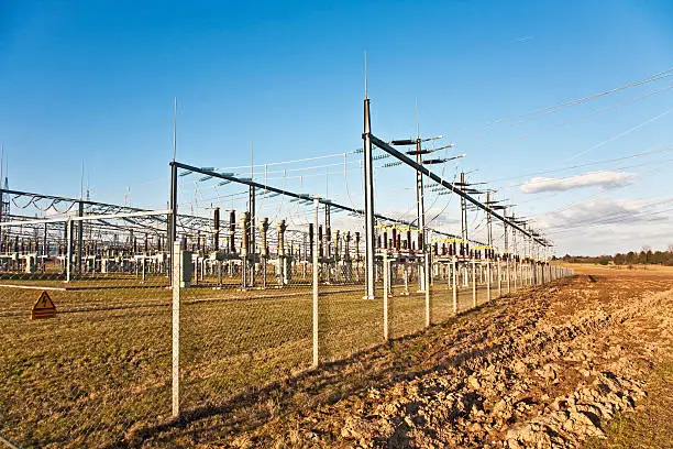 Photo of electricity relay station with high-voltage insulator and power lines