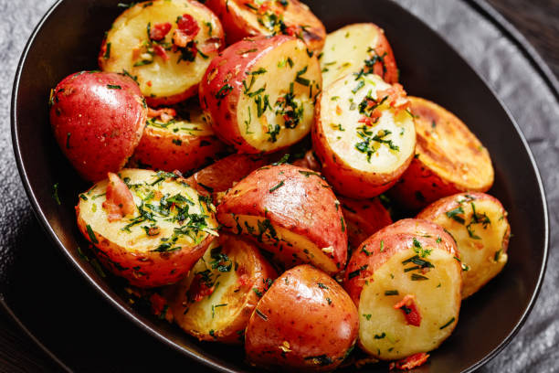 istock Herbs Garlic Potatoes in black bowl, top view 1532762959
