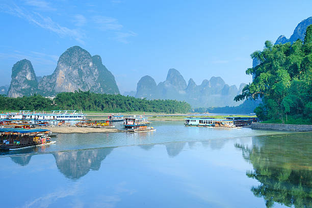 istock trees and hill in reflection of the river 153276406