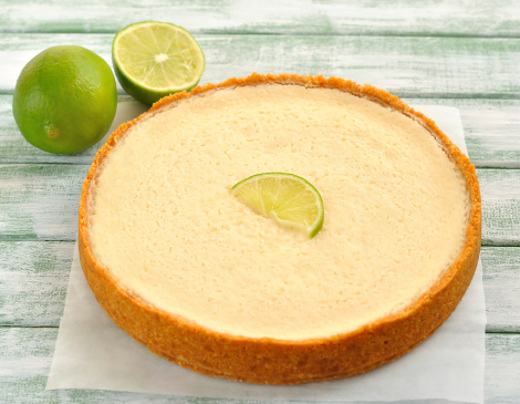 Key Lime Pie and limes on a white table