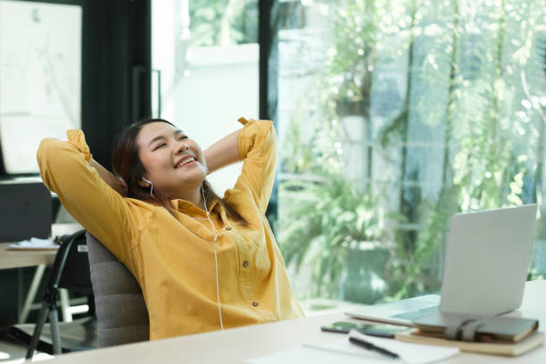 istock Happy young woman working on laptop while sitting at his working place in office 1532771833